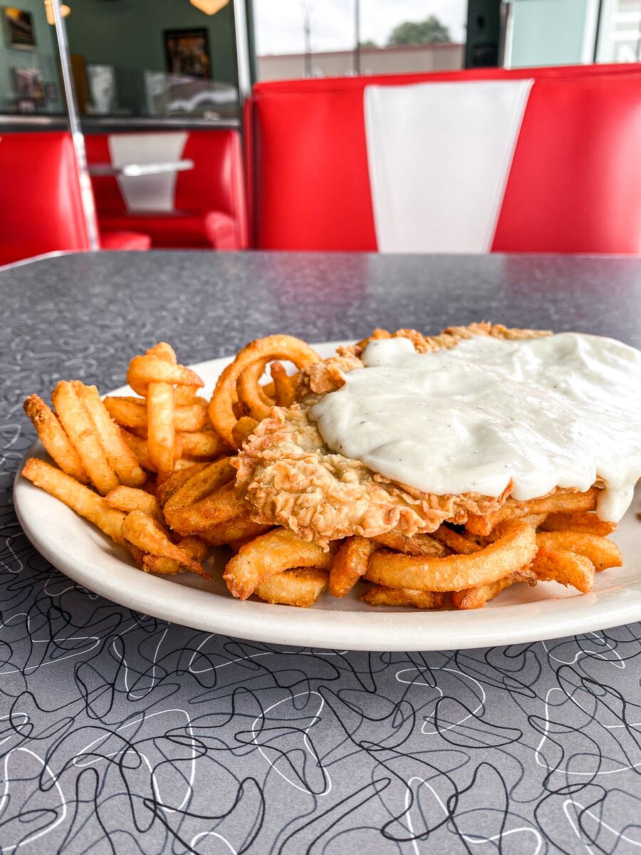 Chicken fried steak with cream gravy and fries