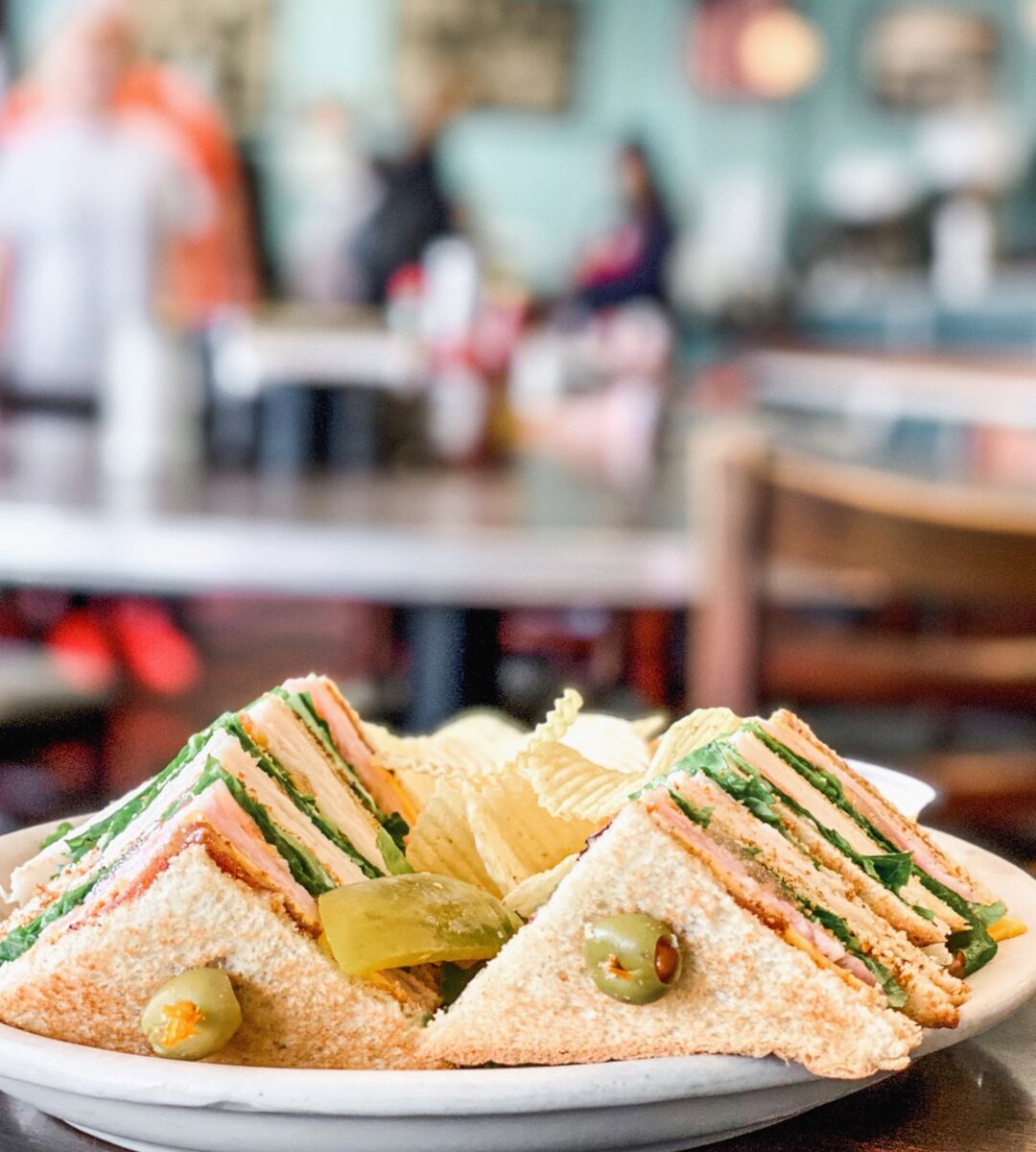 Avalon Club sandwich with chips and a pickle
