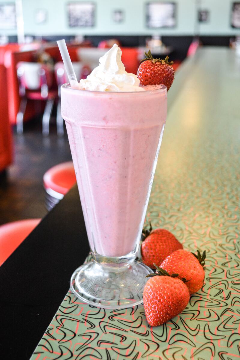 Strawberry milkshake topped with whipped cream